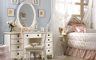white wooden double pedestal dresser with mirror near comforter